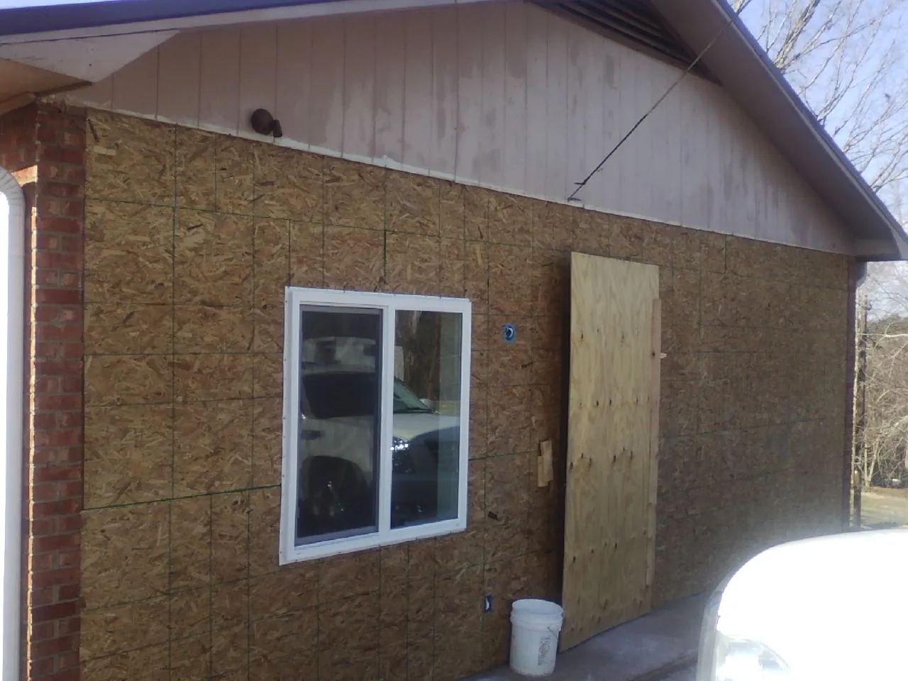 OSB sheathing on a garage addition wall before siding in North Waterboro