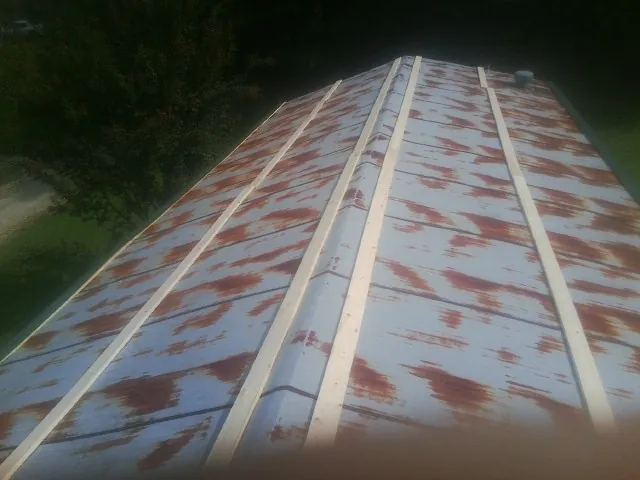 Rusted metal roof panels with new wood purlins before replacement — Storm Damage Roof Repair in North Waterboro by Roofing Brothers