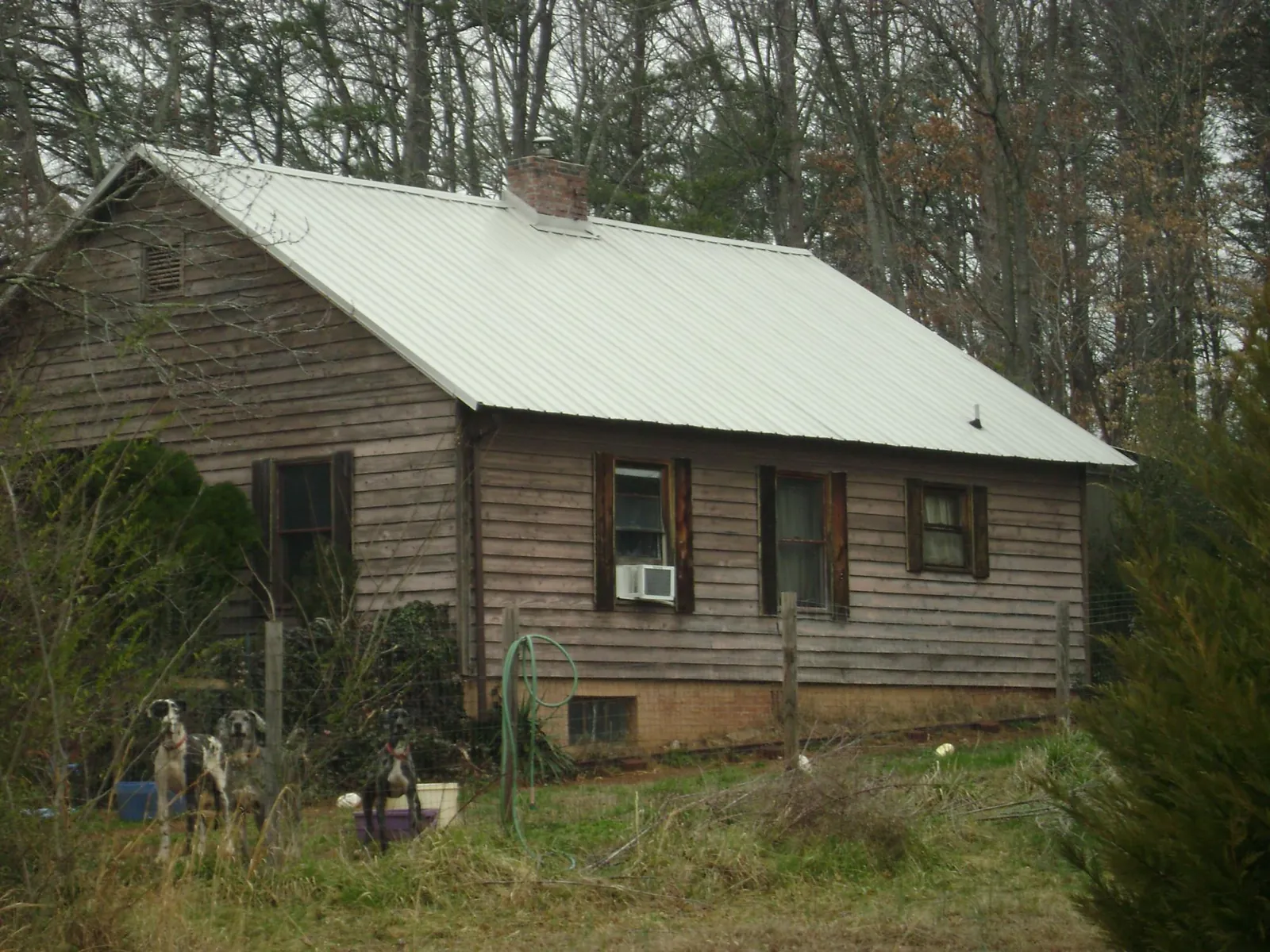 White metal roof on an old wood sided farmhouse, from a Metal Roof Installation job in North Waterboro